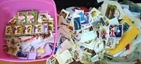 Container of Stamps Unsorted On Paper Off Paper